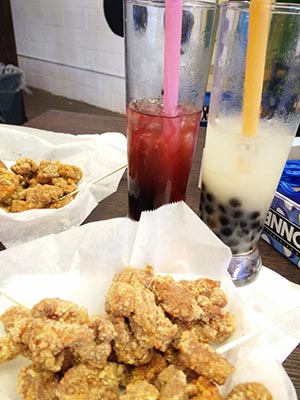 close-up image of popcorn chicken and boba drinks