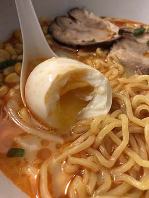 closeup of soy sauce egg in ramen