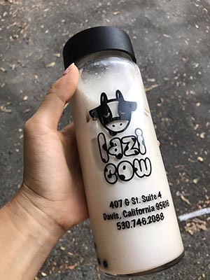 photo of someone holding milk tea in a bottle